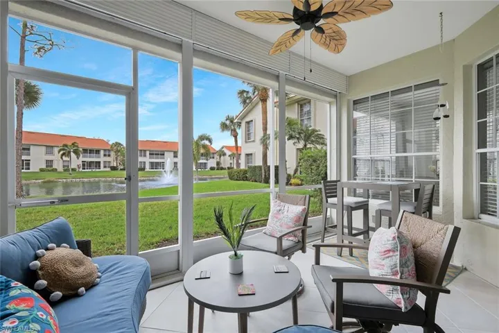 Sunroom / solarium with a ceiling fan, a water view, an outdoor hangout area, and tile patterned floors