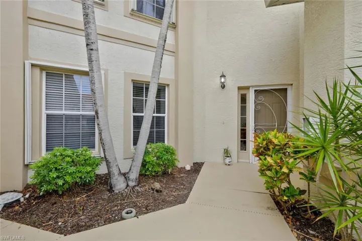 Property entrance featuring stucco siding