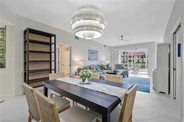Dining area with a ceiling fan and light tile patterned floors