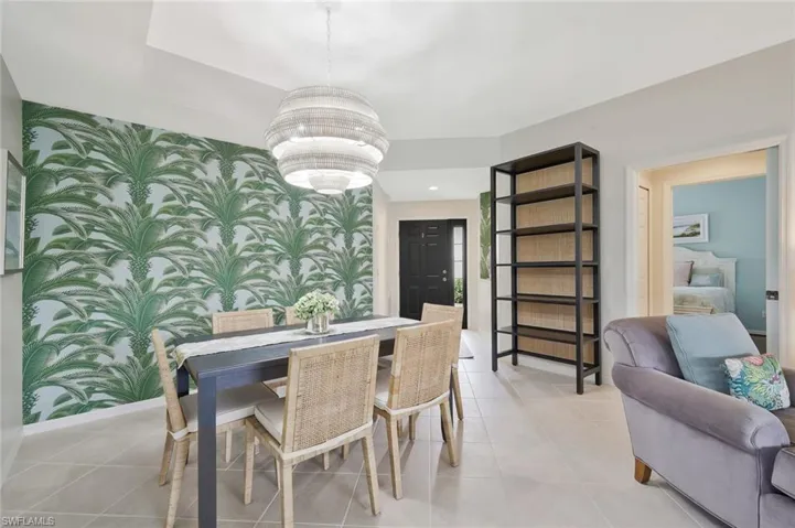 Dining space with wallpapered walls and an accent wall