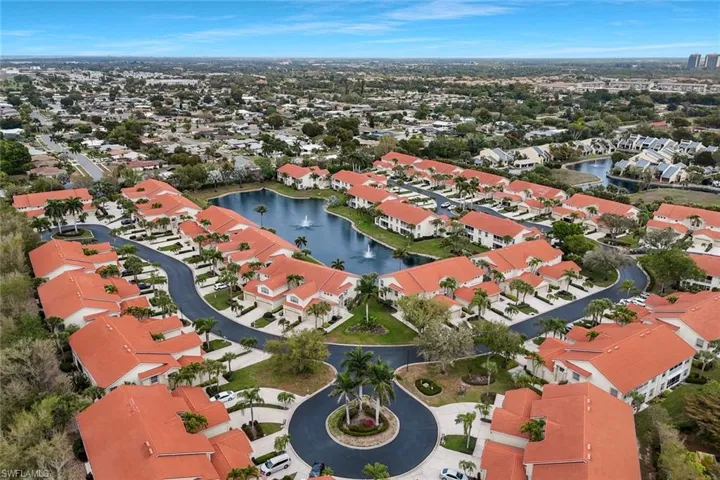 Aerial view of residential area featuring a nearby body of water