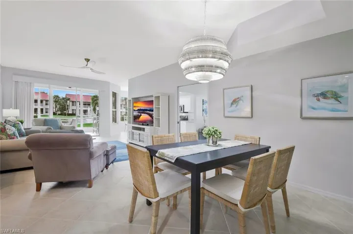 Dining space with ceiling fan and light tile patterned floors