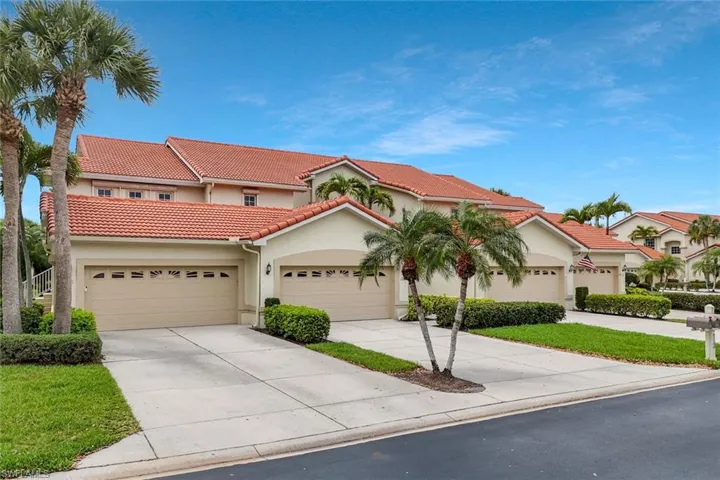 Mediterranean / spanish house with stucco siding, a tiled roof, and driveway