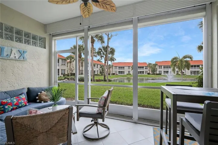 Sunroom with a water view, a ceiling fan, and outdoor seating