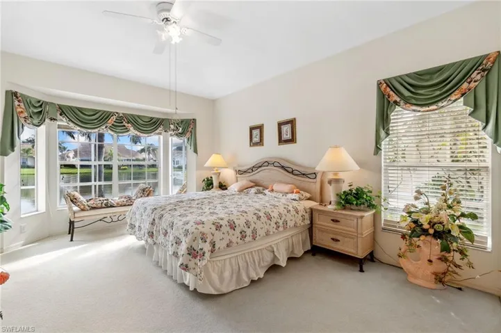 Carpeted bedroom featuring ceiling fan