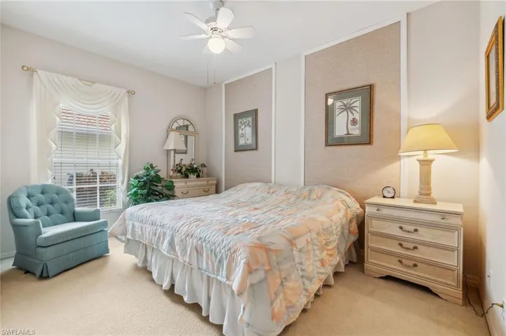 Carpeted bedroom with ceiling fan