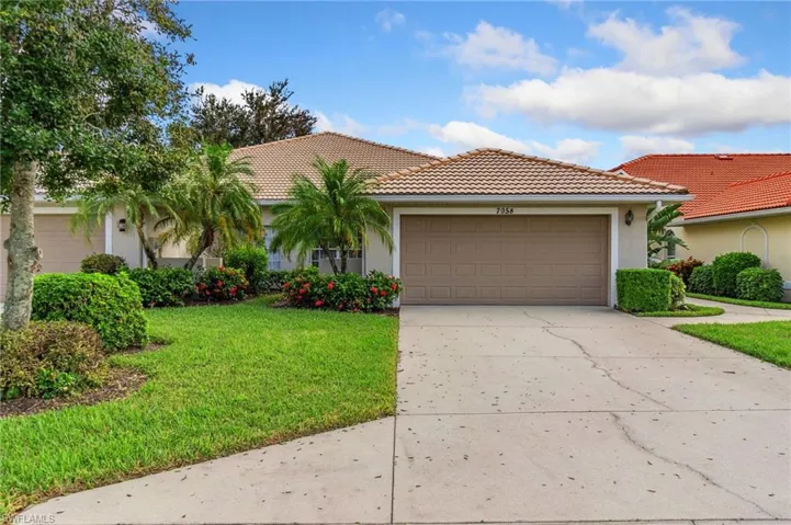 Mediterranean / spanish-style home with a garage and a front yard