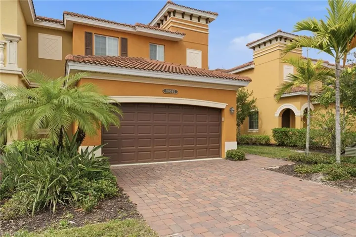 Mediterranean / spanish house featuring decorative driveway, a tiled roof, and stucco siding