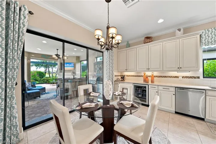 Sliding glass doors opening to an outdoor living area with a paver patio