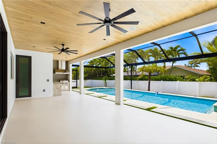 Spacious covered lanai with plenty of room to lounge, dine, and enjoy the poolside setting year-round