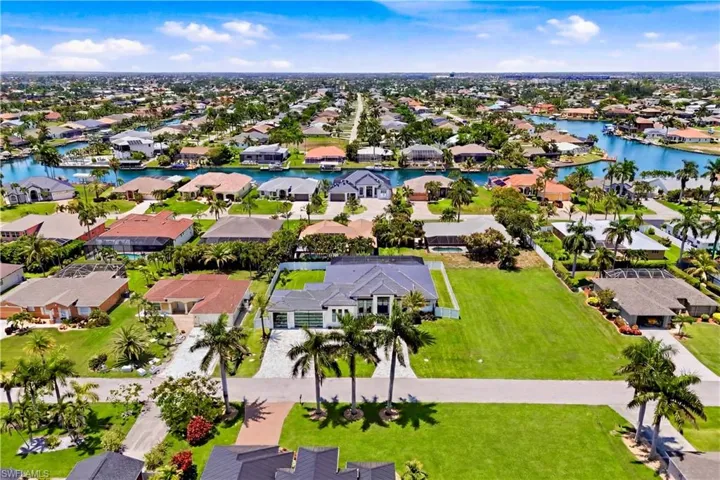 Rare triple-lot setting with an expansive side yard, circular driveway, and prime SW Cape location!