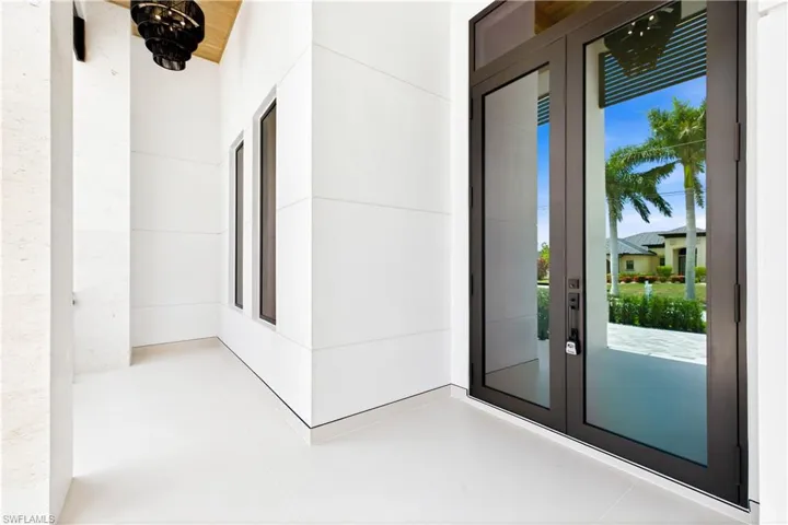 Step through 10-ft tinted Low-E impact double doors into impressive foyer