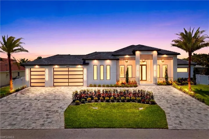 Rare triple-lot modern estate in the heart of SW Cape Coral w/ 4,861 total sq ft