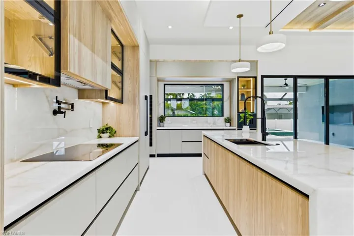 BUTLER'S PANTRY w/ CRISTALLO countertop, glass-front cabinetry, built-in DACOR DUAL-ZONE WINE COOLER & FULGOR MILANO INTEGRATED COFFEE MACHINE