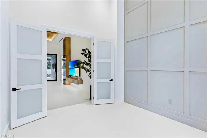 Tall front-facing windows bring in natural light and enhance the bright, airy feel