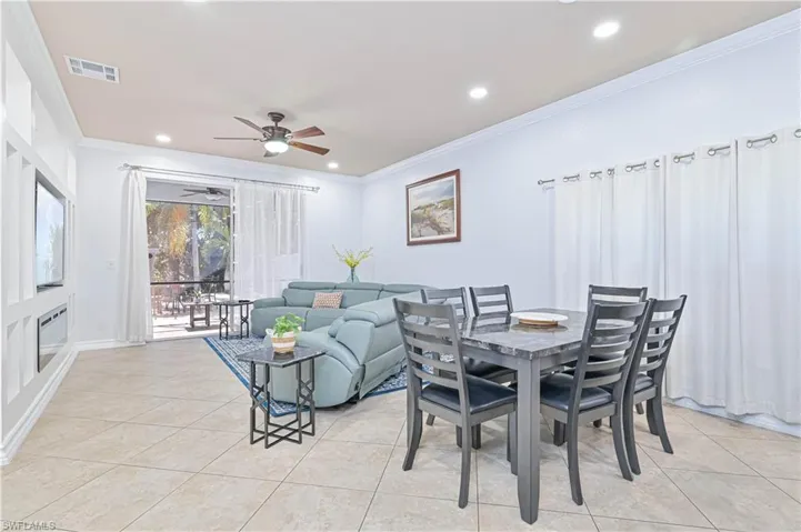 Dining room featuring crown molding, ceiling fan, recessed lighting, and light tile patterned flooring