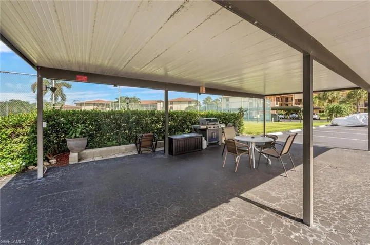 View of patio with a grill