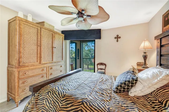 Bedroom featuring tile patterned floors, ceiling fan, and access to exterior