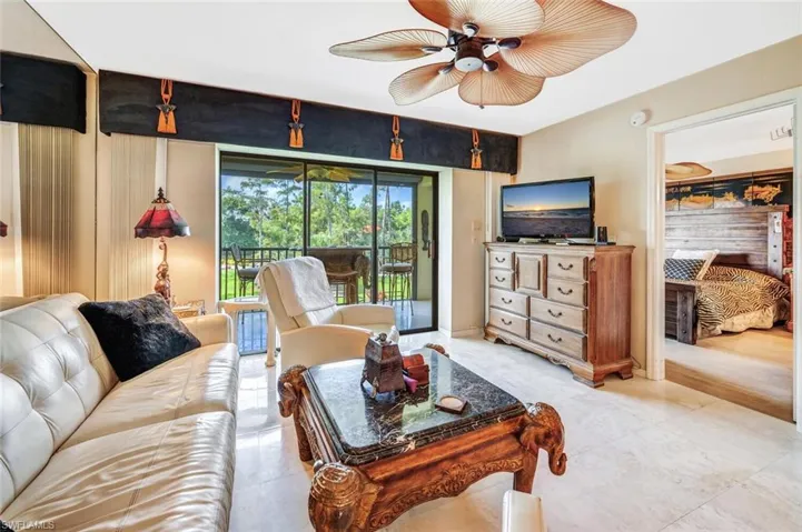 Tiled living room featuring ceiling fan