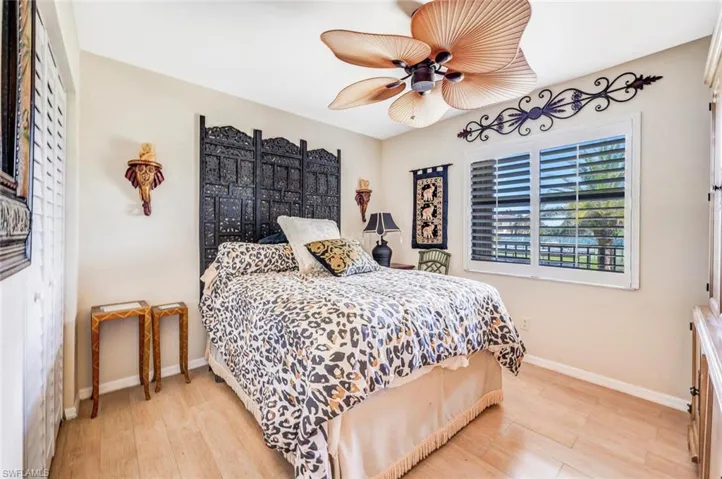 Bedroom with ceiling fan and light hardwood / wood-style flooring