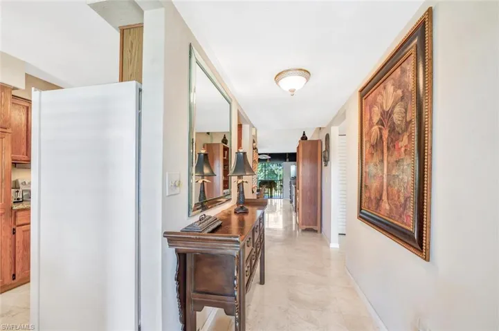 Hall featuring light tile patterned floors