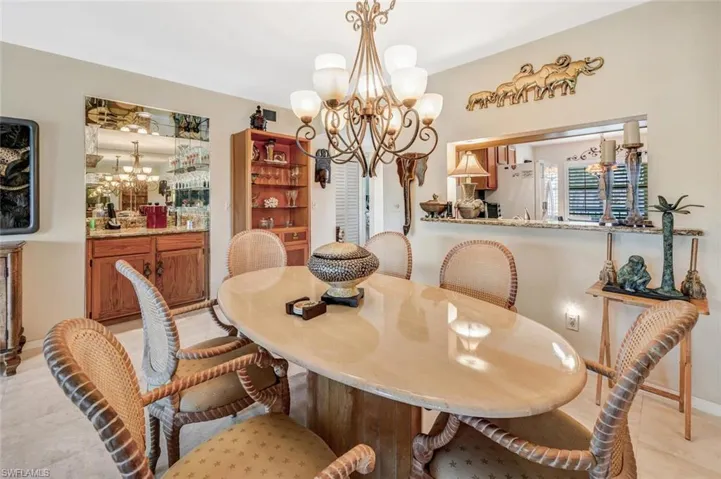 Tiled dining space featuring a chandelier