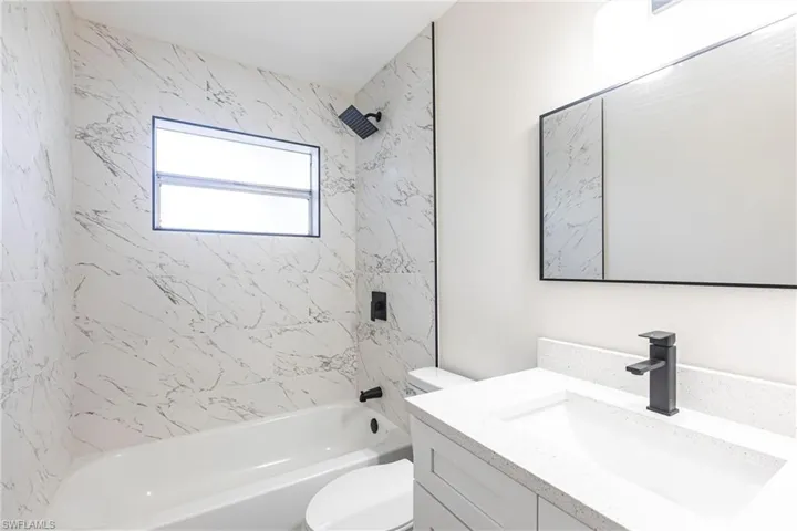 Bathroom featuring vanity and bathing tub / shower combination