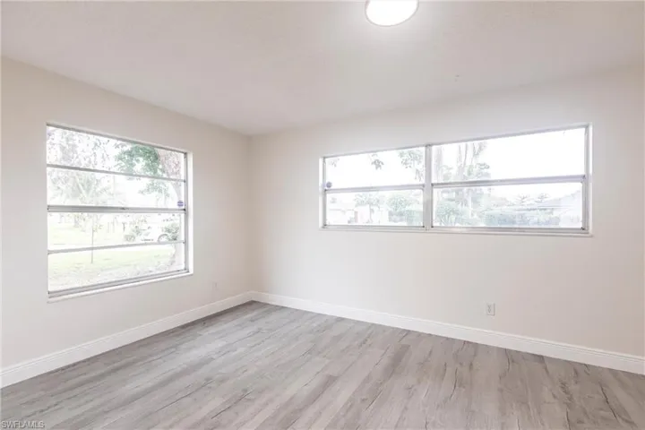 Empty room with light wood finished floors and baseboards