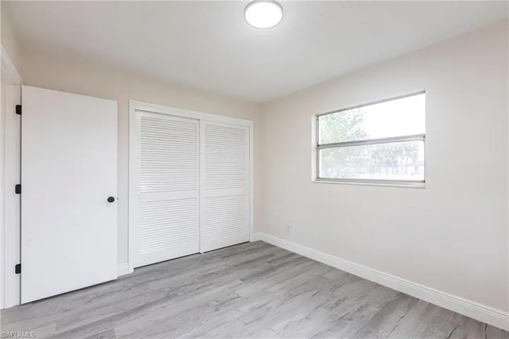 Unfurnished bedroom featuring light wood-type flooring and a closet