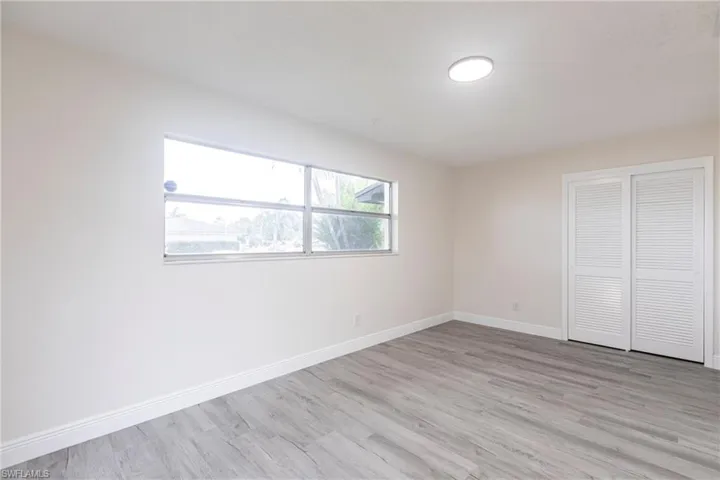 Unfurnished bedroom featuring light wood-style floors and a closet