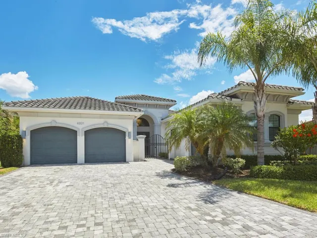 Mediterranean / spanish-style home with an attached garage, decorative driveway, a tiled roof, and stucco siding