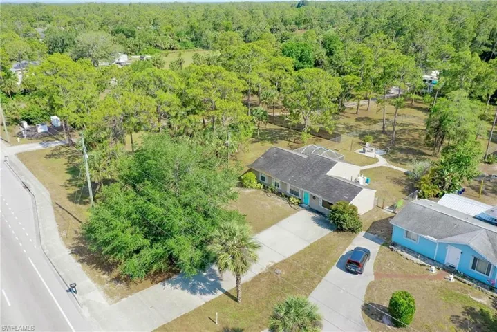 Birds eye view of property featuring a wooded view