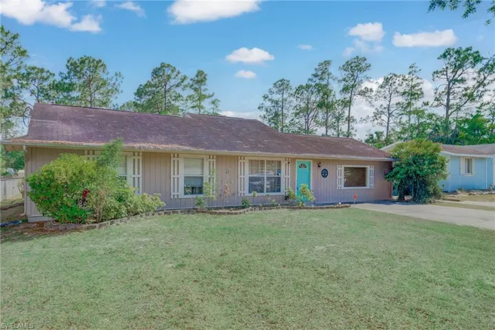 Ranch-style house featuring a front lawn
