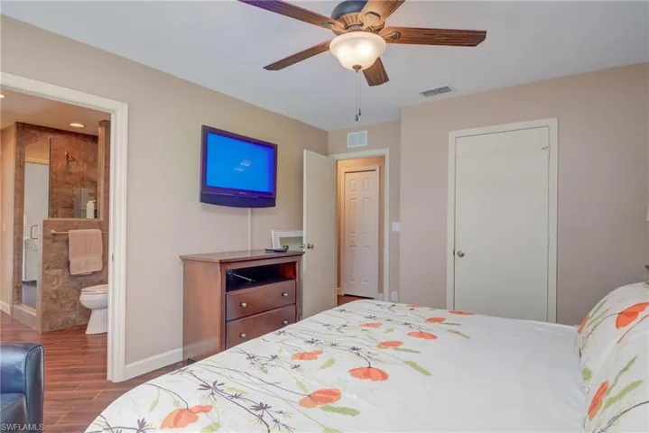 Bedroom featuring visible vents, wood finished floors, and baseboards