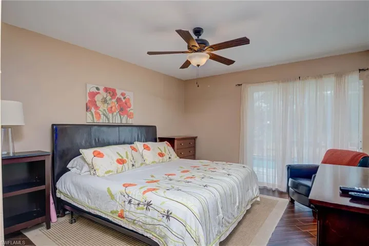 Bedroom with wood finished floors and a ceiling fan