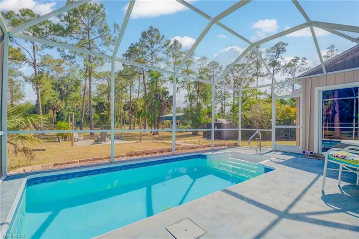 Pool featuring a lanai, a fenced backyard, and a patio area