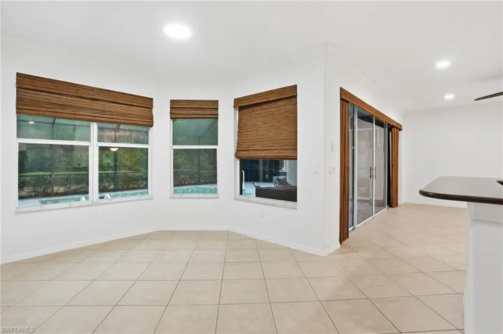 Dining area featuring ornamental molding, recessed lighting, light tile patterned flooring, and ceiling fan