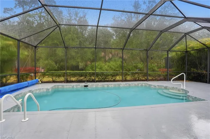 Swimming pool with a lanai and a patio