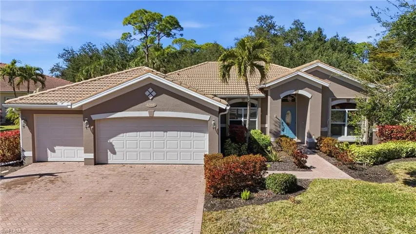 Mediterranean / spanish-style home with stucco siding, decorative driveway, a tiled roof, and an attached garage