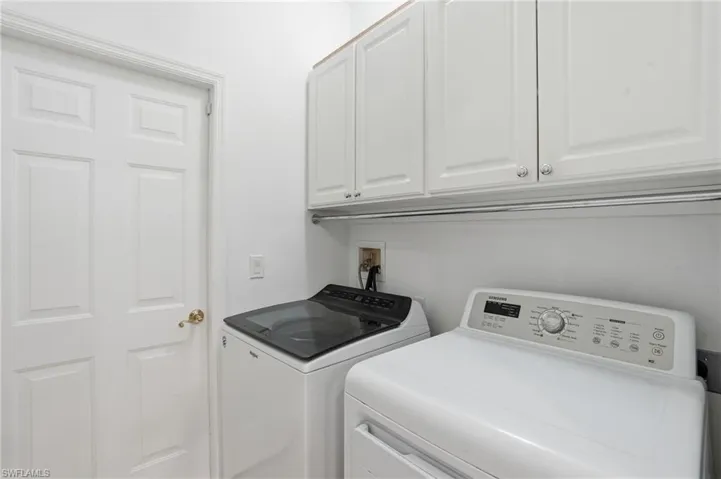 Laundry room with washing machine and dryer and cabinet space