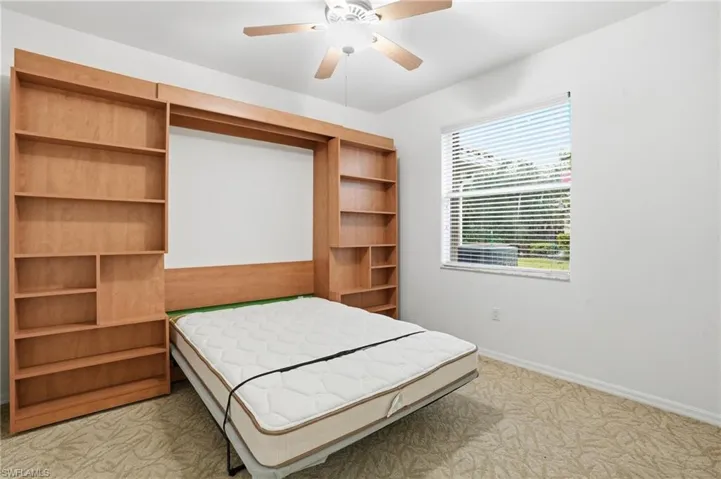 Bedroom 1 with builtin shelves and Murphy bed