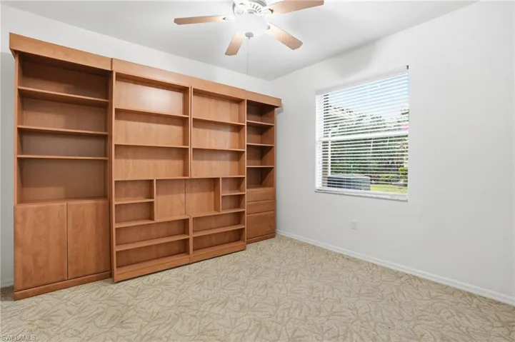 Bedroom 1 with builtin shelves and Murphy bed