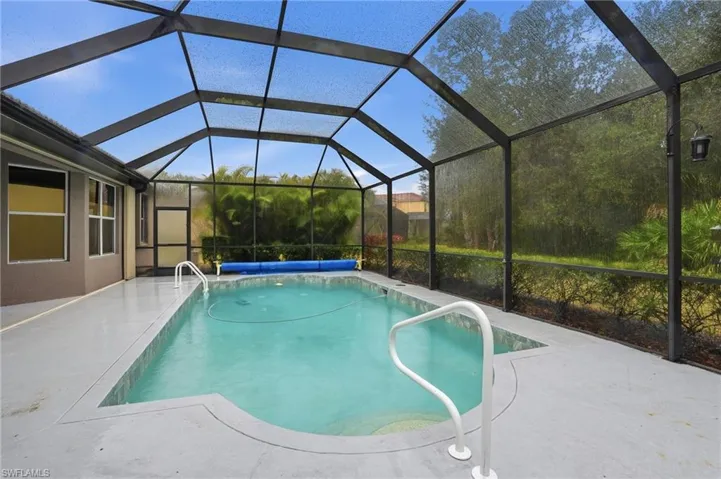 View of pool featuring a covered pool, a lanai and patio
