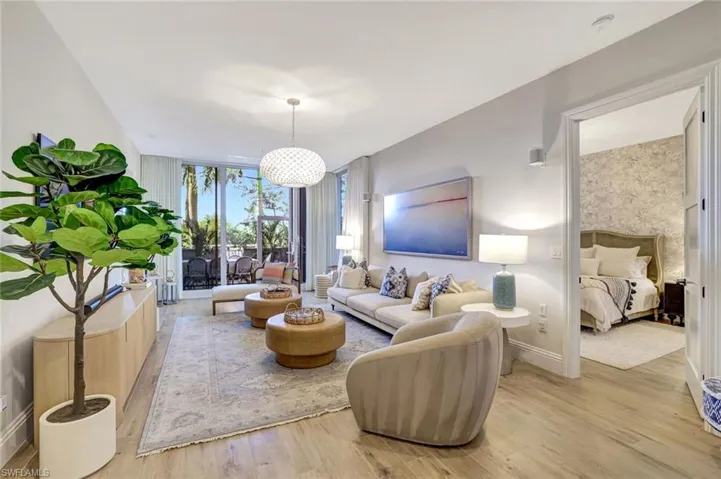 Living room with expansive windows and light wood finished floors