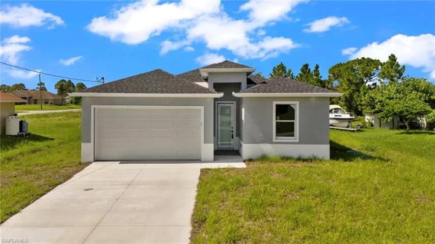 View of front of home featuring a garage and a front yard