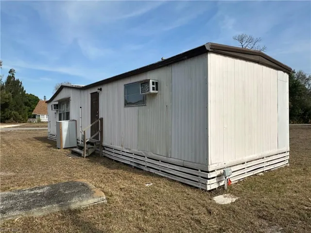 View of outbuilding with entry steps