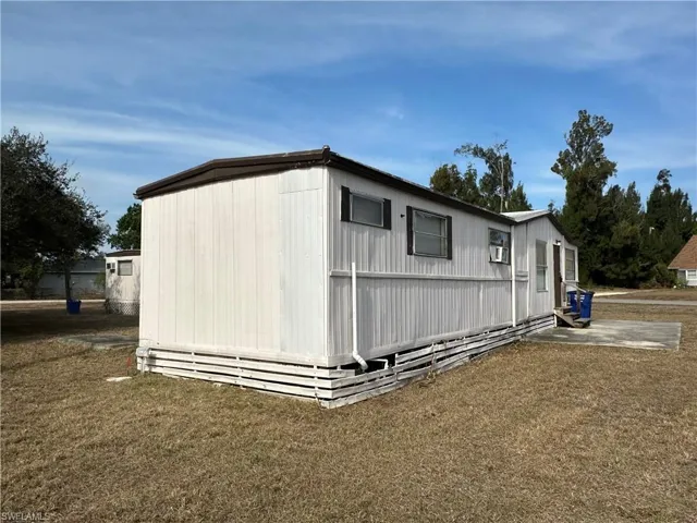 View of property exterior featuring a yard