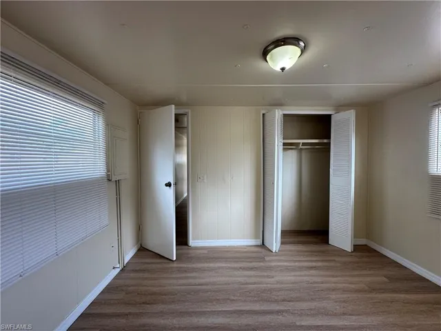 Unfurnished bedroom with light wood finished floors and a closet
