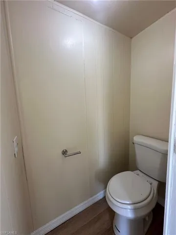 Bathroom featuring toilet and wood finished floors