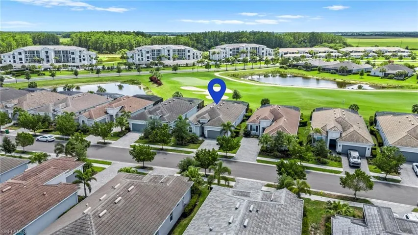 Birds eye view of property with view of golf course, a residential view, and a water view